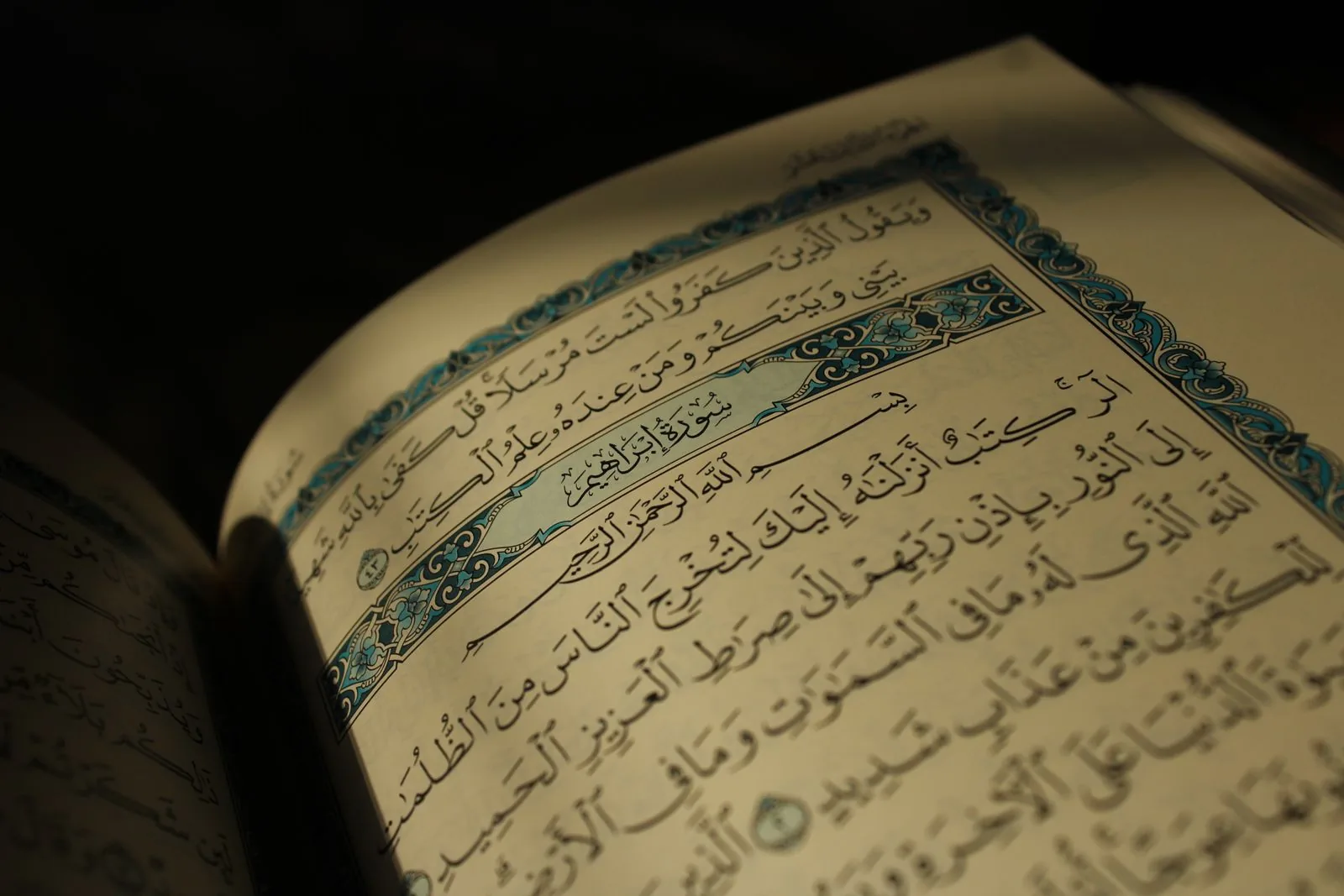 Açıq Quran — ərəb əlifbası ilə ayələr, isti işıqda